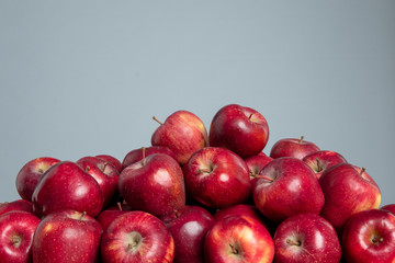 Red apples on the grey isolated background