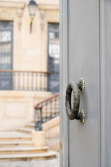 Entrance door and knocker of beautiful city center French luxury house