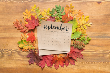 Overview of September calendar surrounded by colorful autumn leaves