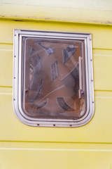 The orange house in the neighborhood of yellow camper