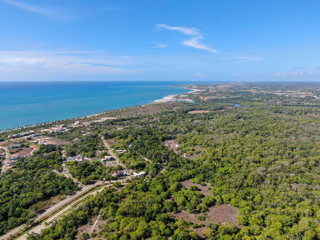 Fototapeta na wymiar Aerial view of Praia Do Forte coastline town with blue ocean