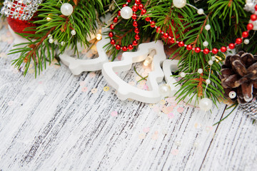 Christmas tree branches with cones, beads, luminous garlands. Fragment of Christmas decorations in...