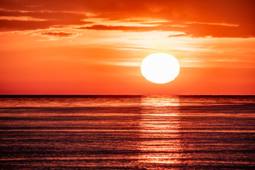 Fototapeta na wymiar Beautiful red and orange sunset over the sea. The sun goes down over the sea.