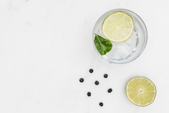 Gin Tonic Cocktail Drink In Glass On White Marble Background