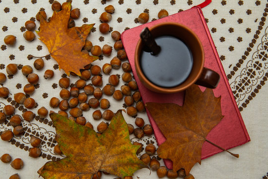 Autumn sentiment. Pictures of Autumn Coffee, Leaves, Books, Hazelnuts and Flowers.