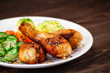Grilled chicken drumsticks with boiled potatoes and vegetables