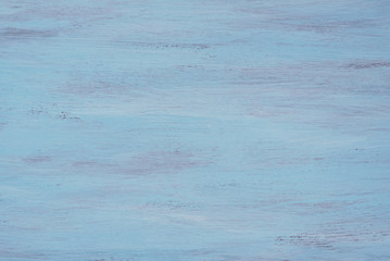 Old textured wooden desk painted in deep blue color