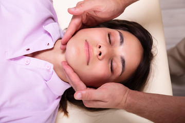 Fototapeta na wymiar Beautiful Young Woman Getting A Jaw Massage