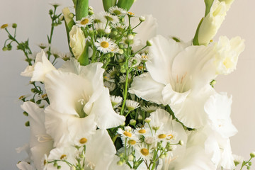 Bouquet of white gladioli. Whiteness delicate gladiolus flowers. Close up on white background