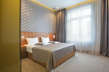 Fototapeta na wymiar Hotel bedroom interior in the morning