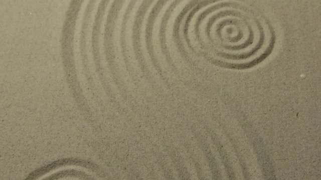 Panorama. Circles and curve lines on the sand. Texture of sand.
