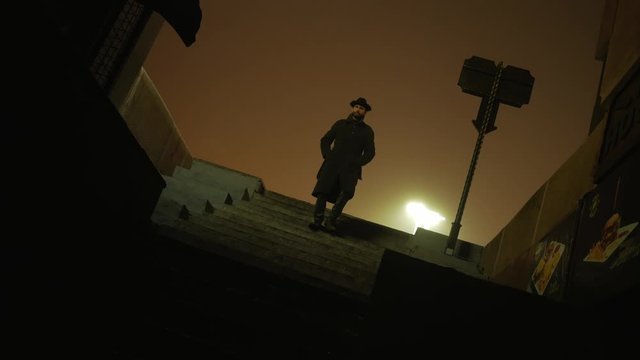 Dark silhouette of man  with hat walking down the stairs