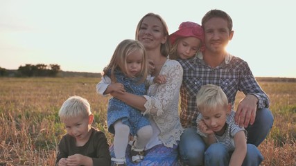 Large family on a background of evening sunset.