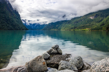 clouds and the stones on Oldenvatnet lake in Norway