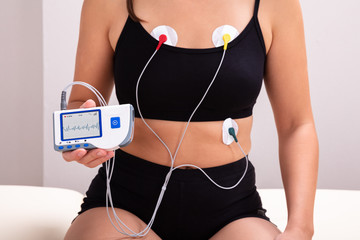 Patient With Holter Monitor Device On Her Body In Clinic