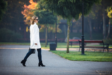 Middle-aged woman walking in city park