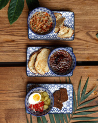 A variety of dishes on a wooden table. Restaurant serving. Top view.