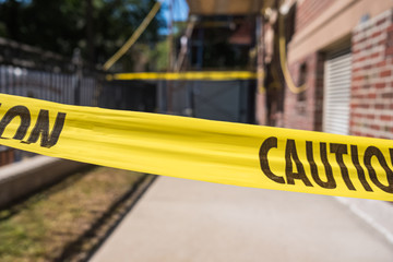 Yellow caution tape in front of building