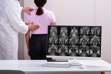 Doctor Consulting With Patient Back Problem