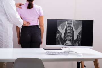 Doctor Consulting With Patient Back Problem