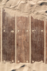 wooden texture of old wood and sand of a walkway on the beach