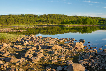 stones, crystal water on the lake Kovdozero in Zelenoborsky village near Kandalaksha. Kola Peninsula, Russia.