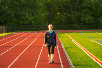 Middle age woman staying fit on track