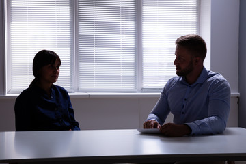 Male Psychologist Discussing Questions With Her Patient In Room