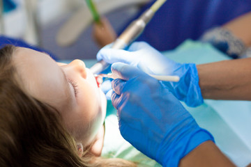 little girl sitting in the dentist chair. Children dentist examination baby teeth. dental treatment for children. caries prevention in kids