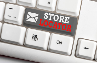 Conceptual hand writing showing Store Locator. Concept meaning to know the address contact number and operating hours White pc keyboard with note paper above the white background