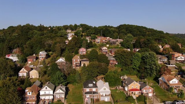 A high angle profile aerial view of typical Pennsylvania homes in late summer. Pittsburgh suburbs.  	