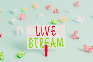 Conceptual hand writing showing Live Stream. Concept meaning transmit or receive video and audio coverage over Internet Colored clothespin rectangle shaped paper blue background