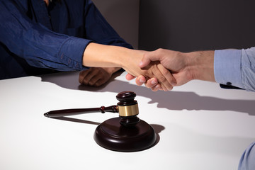 Notary And Client Shaking Hands In Office