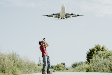 Photographer taking pictures of a very large plane
