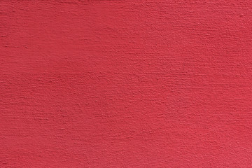 Bright rough plastered surface. Living coral colored. Backgrounds and textures