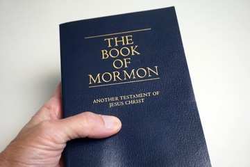 Person holding The Book of Mormon - obrazy, fototapety, plakaty