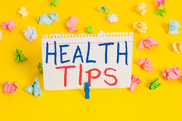 Word writing text Health Tips. Business photo showcasing state of complete physical mental and social well being Colored crumpled papers empty reminder white floor background clothespin