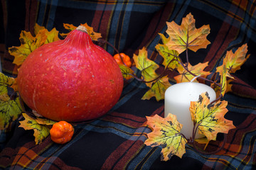 Autunm composition with pumpkin, candles and leaves. Concept autumn comfort