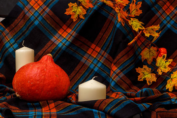 Autunm composition with pumpkin, candles and leaves. Concept autumn comfort