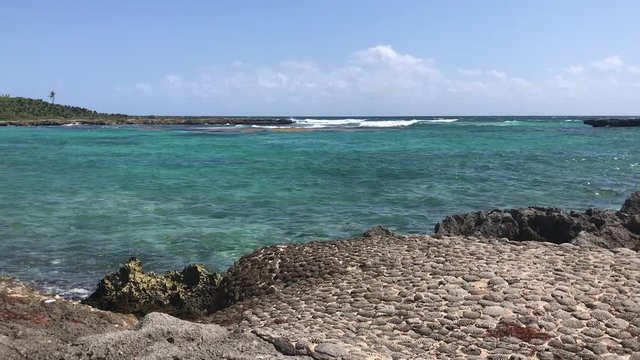 Wide iphone shot of ocean waves by a reef lagoon in Akumal Mexico