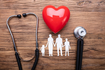 Family Cut Out With Stethoscope And Red Heart On Desk