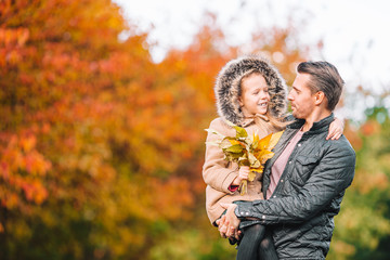 Family of dad and kid on beautiful autumn day in the park