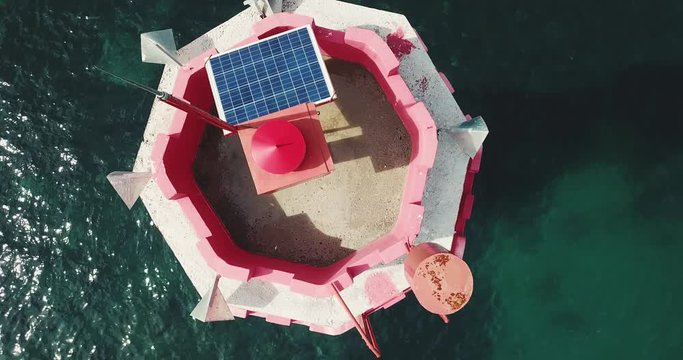 Aerial view of lighthouse and Solar battery on sea
