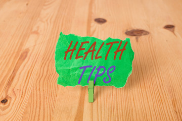 Text sign showing Health Tips. Business photo showcasing state of complete physical mental and social well being Empty reminder wooden floor background green clothespin groove slot office