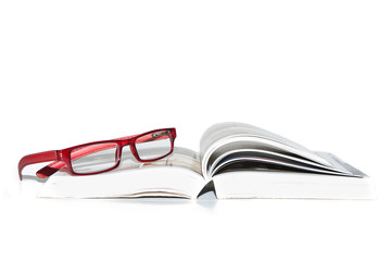 Book and reading glasses on a white background