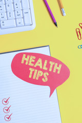 Text sign showing Health Tips. Business photo showcasing state of complete physical mental and social well being Pink empty paper on the yellow table with pencil
