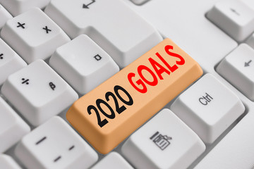 Handwriting text writing 2020 Goals. Conceptual photo A plan to do for something new and better for the coming year White pc keyboard with empty note paper above white background key copy space
