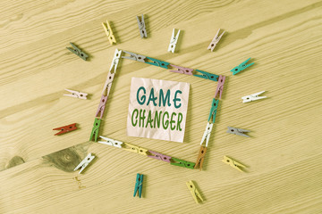 Text sign showing Game Changer. Business photo showcasing Sports Data Scorekeeper Gamestreams Live Scores Team Admins Colored clothespin papers empty reminder wooden floor background office