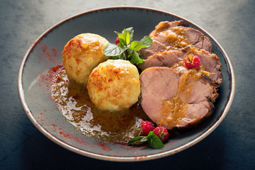 Juicy pork meat with mashed potatoes in sauce.