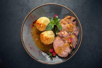 Juicy pork meat with mashed potatoes in sauce.